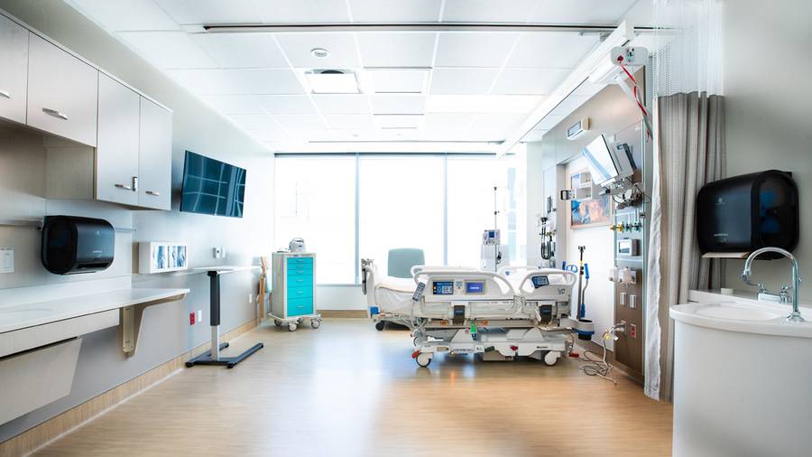 A large Intensive Care Unit (ICU) patient room with a window equipped with the latest in patient monitoring technology.
