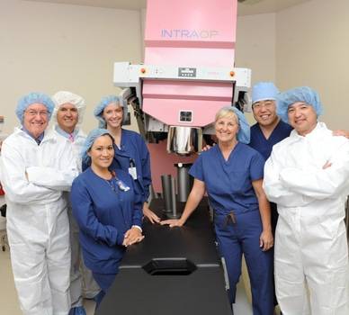 Oncologists gather for a photo near the INTRAOP machine.