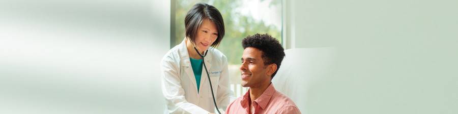 Scripps physician Siu Ming Geary, MD, checks a patient with a stethoscope.
