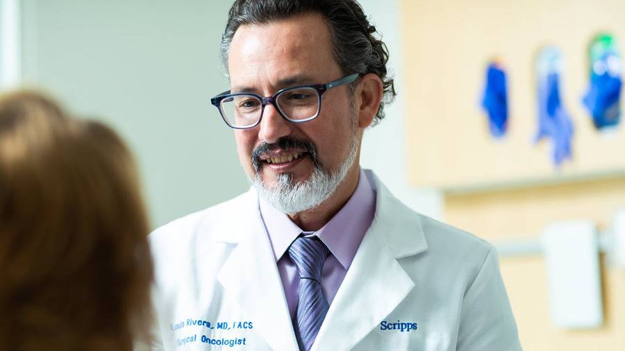 Louis Rivera, MD, surgical oncologist, Scripps Cancer Center, talks to a patient about treatment plans.