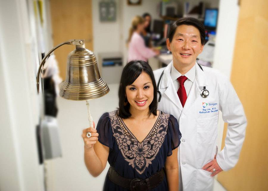 Michelle Fernandez, Breast Cancer survivor, rings a bell, celebrating her successful treatment.