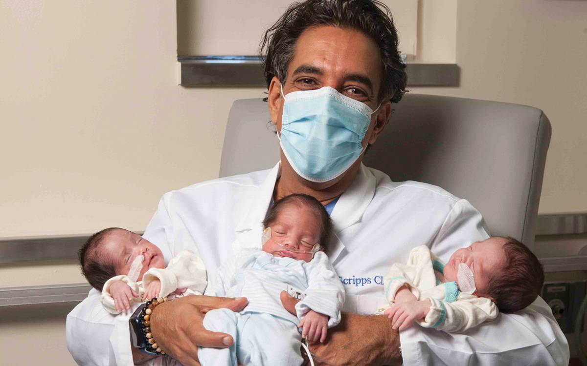 Sean Daneshmand, MD, holds triplets that were successfully delivered through Scripps' comprehensive perinatology program.