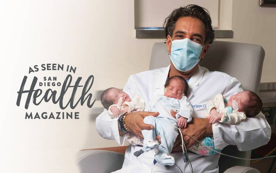 Sean Daneshmand, MD, holds triplets that were successfully delivered through Scripps' comprehensive perinatology program.