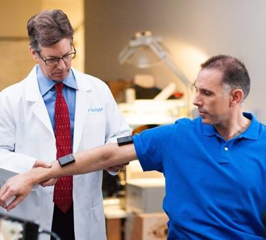 An orthopedist performs a movement test on a patient.