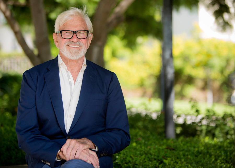 Donor Richard Woltman smiles at the camera while seated in a park.