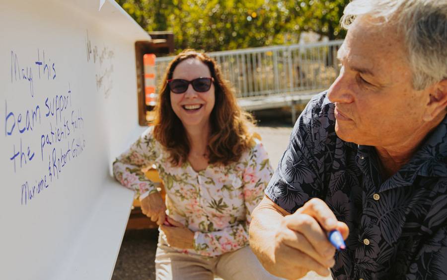 Robert and Marianne Gottlieb add their good wishes to the beam. The Lusardis, Ecke and the Gottliebs are part of Scripps' generous donor community.