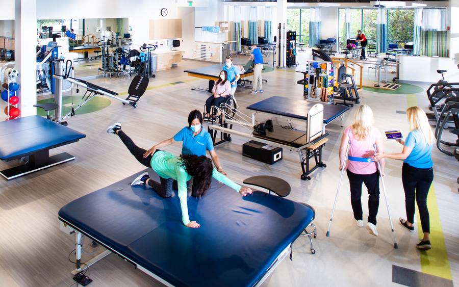 Physical therapists work with patients at Scripps Encinitas Rehabilitation Center using a variety of stretching and strength exercises.