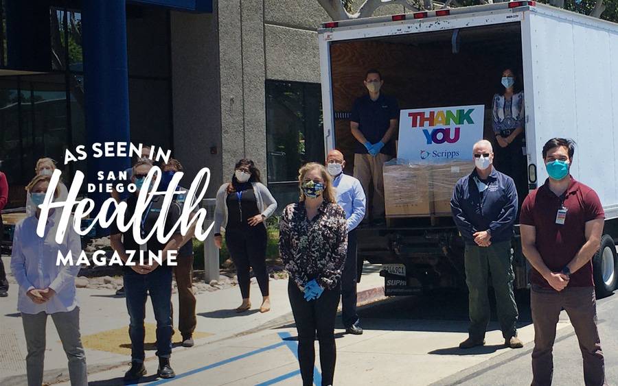 Members of the Scripps Health administration stand near a truck to unload COVID supplies donated by the San Diego community.