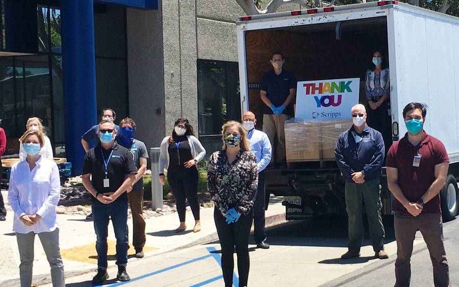 Members of the Scripps administration unload N95 masks donated by SONY.
