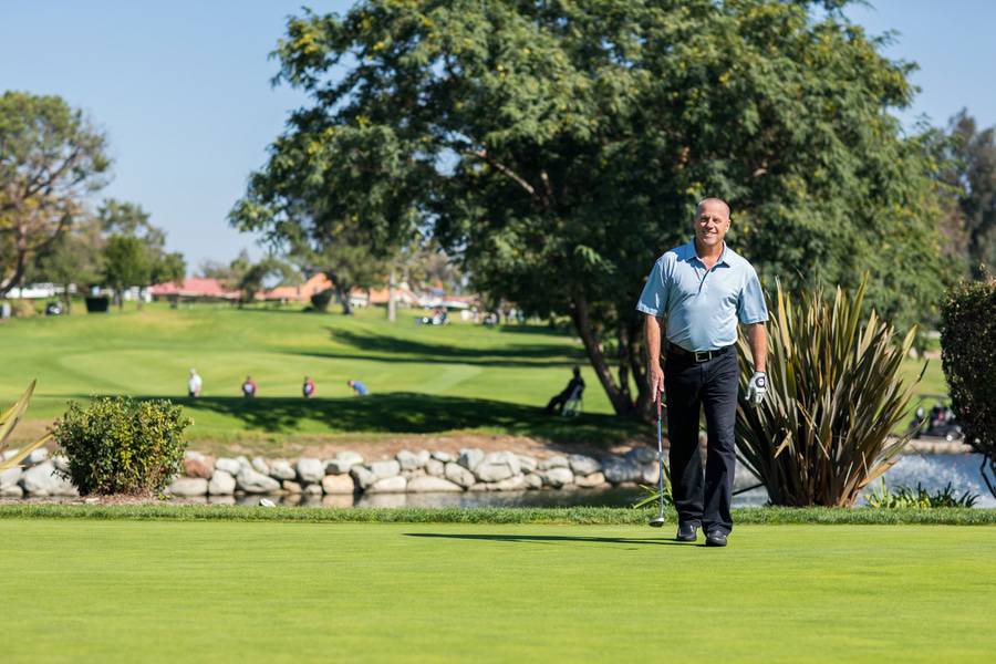 After successful cancer treatment, Steve Young smiles on the golf course.