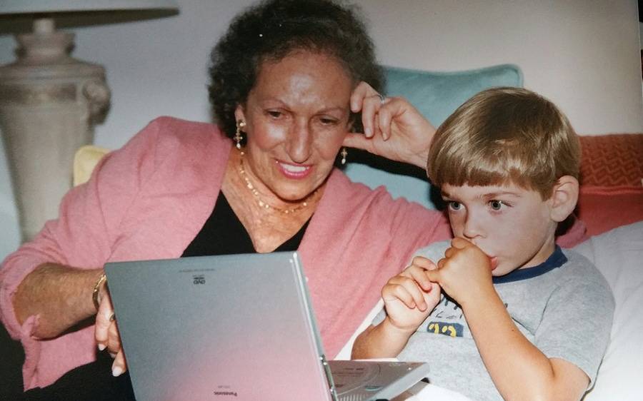 A breast cancer patient watches a movie on a portal device with her young son.