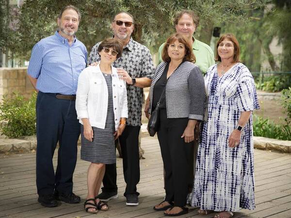 Members of the Cohn family standing on a patio 