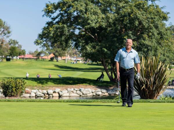 After successful cancer treatment, Steve Young smiles on the golf course.